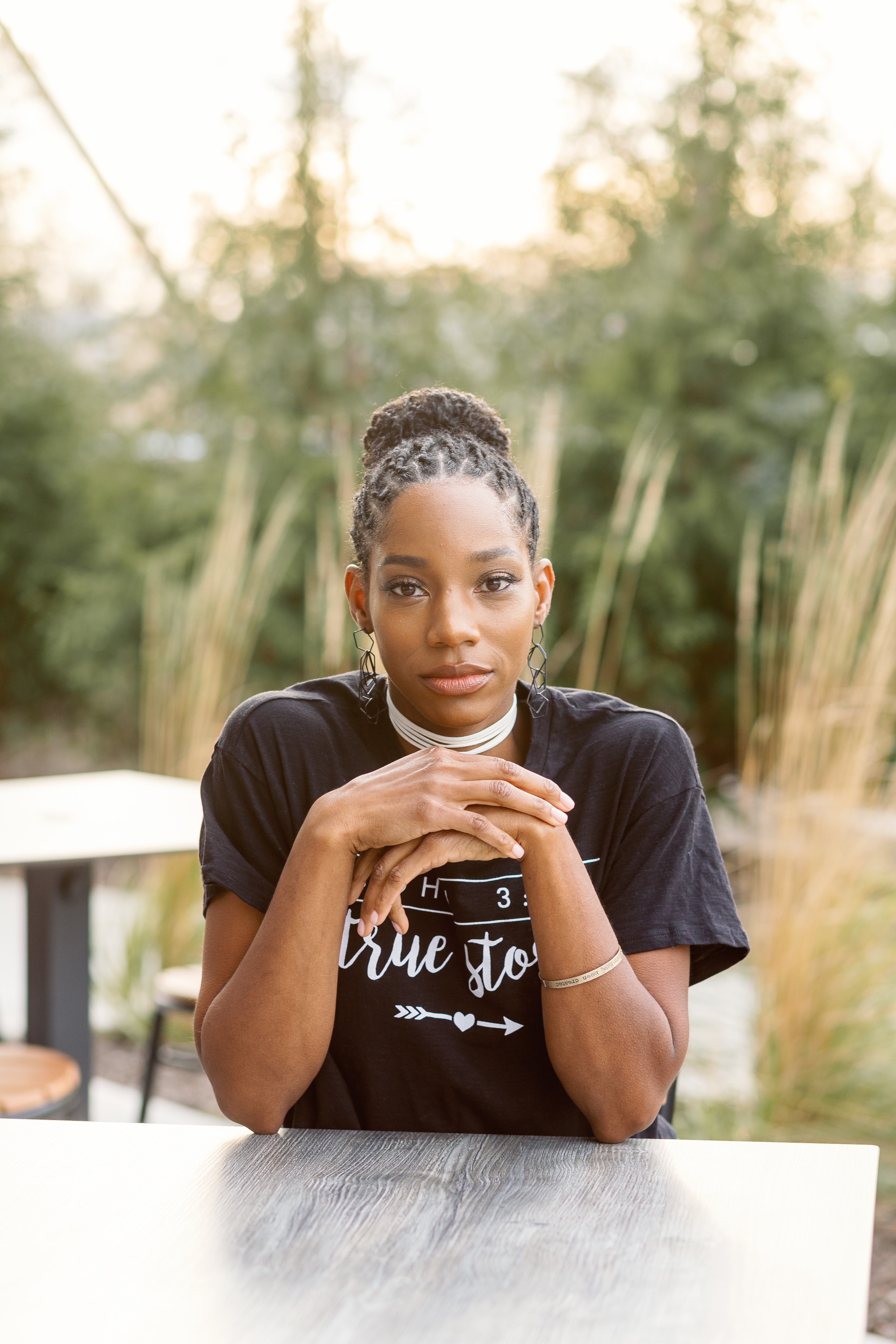 Jovana Scott relaxing at an outdoor table, at ease and grounded
