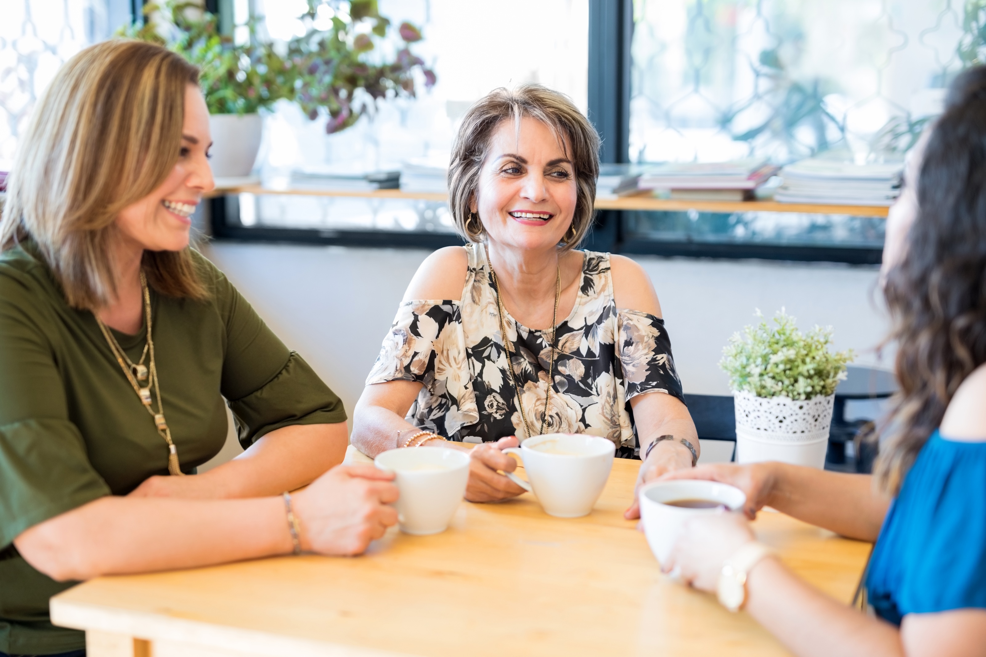 Women relaxing and connecting together in a warm cafe setting