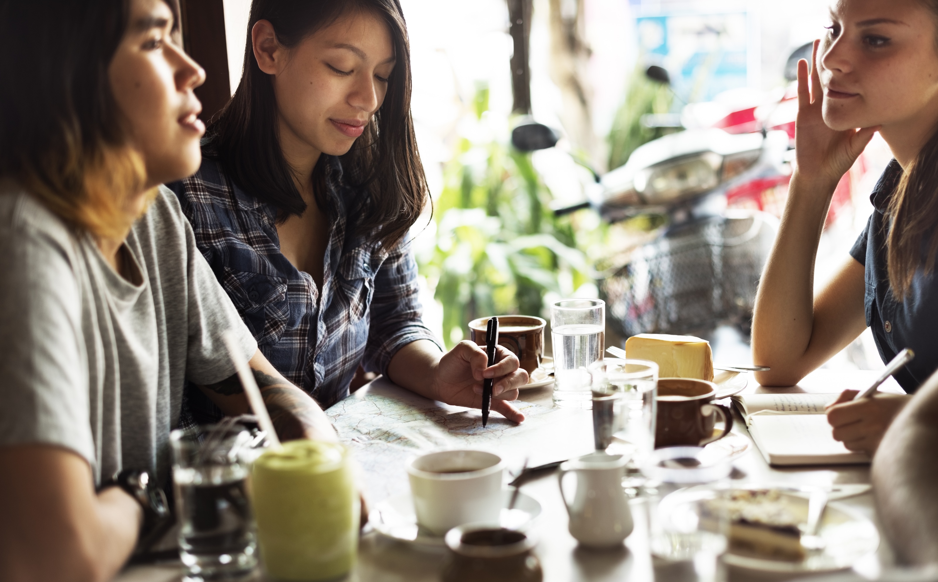Women gathered around coffee, connecting in person in a relaxed setting