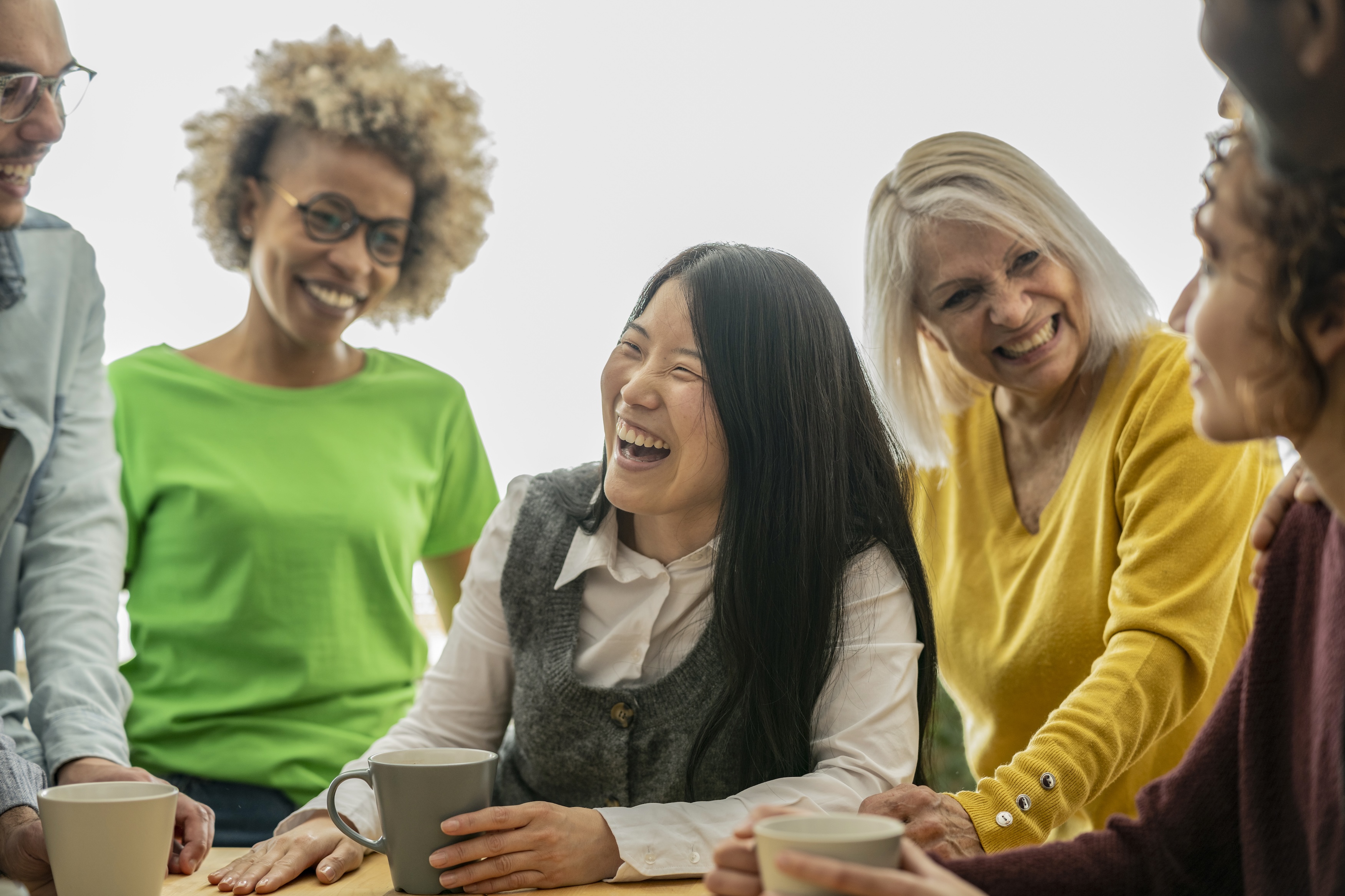 A diverse group of women sharing warmth and connection over coffee
