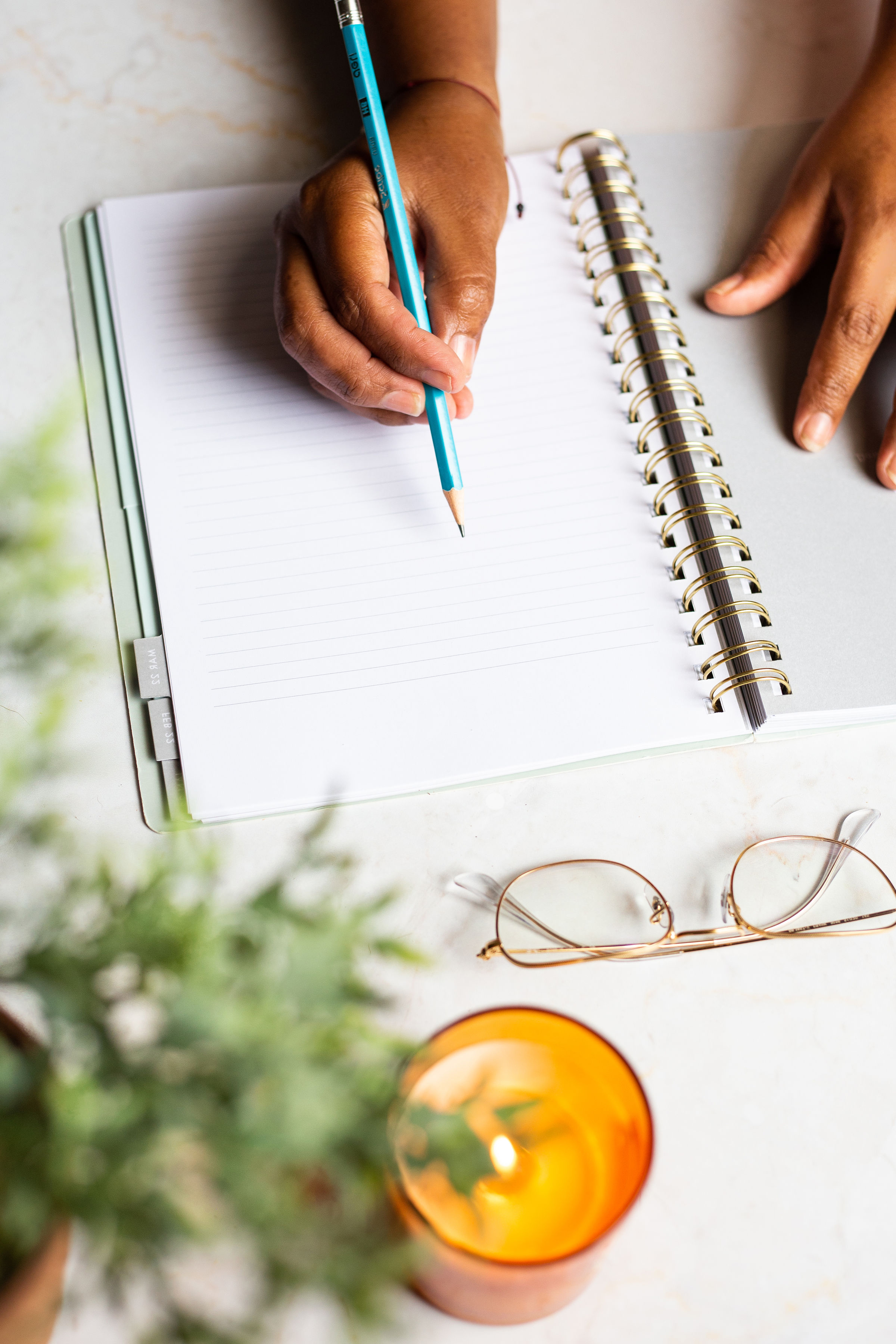 A woman journaling at home, creating space for reflection and planning